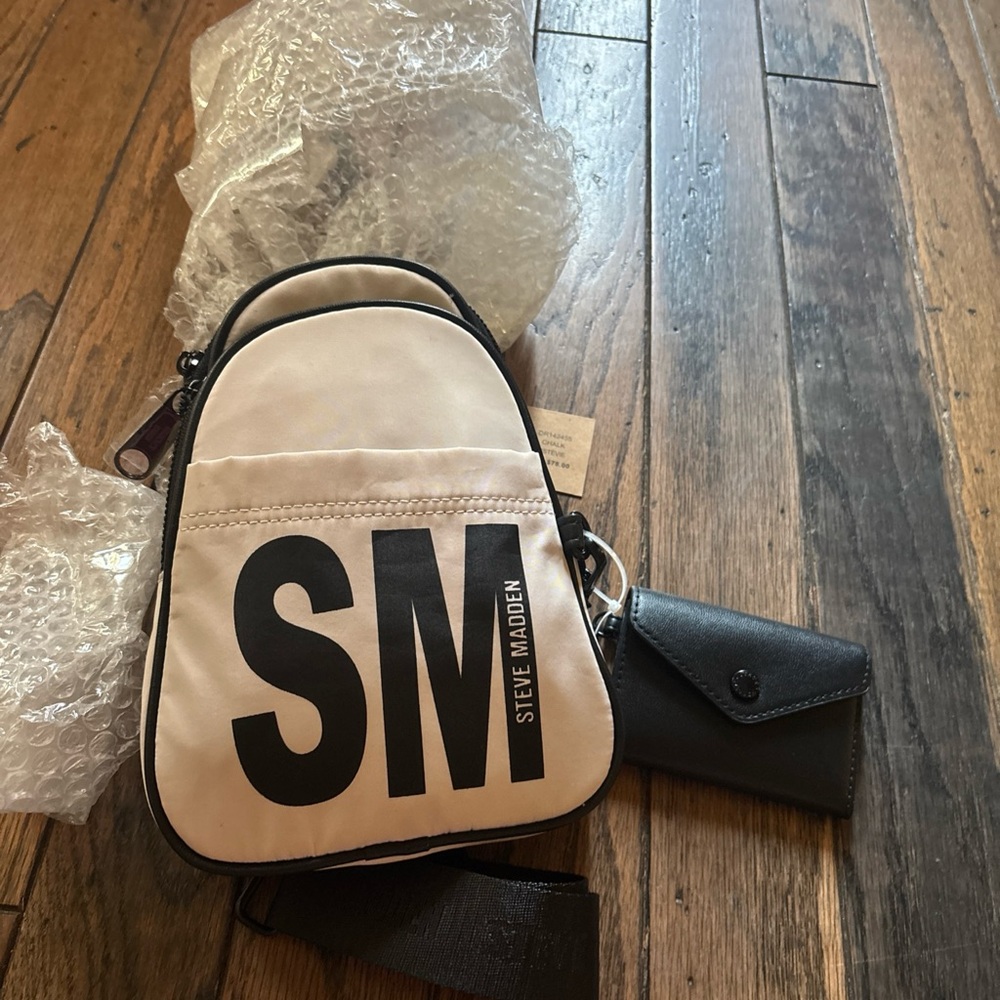 Steve Madden Cream and Black woman’s crossbody bag.